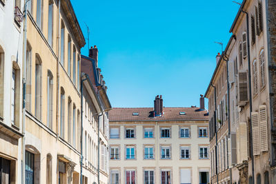 Low angle view of buildings against blue sky