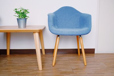 Empty chairs and table against wall at home