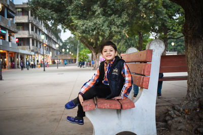 Portrait of teenage girl sitting outdoors