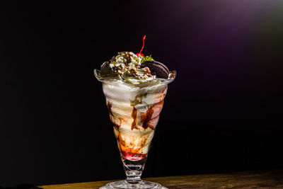 Close-up of ice cream cone against black background