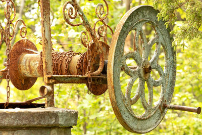 Close-up of rusty machine part on field