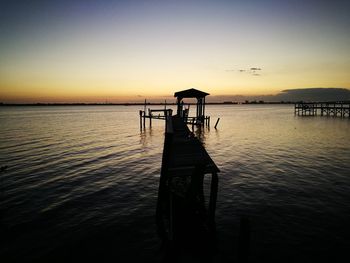 Scenic view of sea against clear sky at sunset