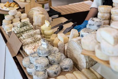Caciotta cheese and other types of italian cheeses on display for sale in the store.