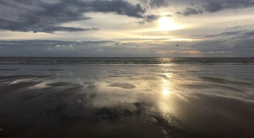 Scenic view of sea against cloudy sky