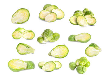 Close-up of green fruits against white background