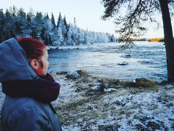 Boy in snow covered land