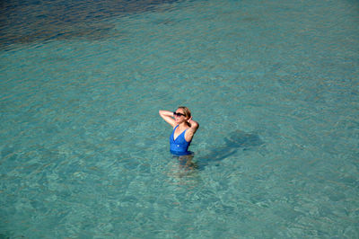 High angle view of young woman swimming in sea