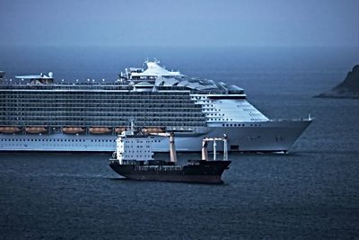 Ship sailing in sea against sky