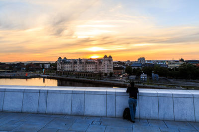 Rear view of woman walking on bridge