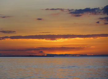 Scenic view of sea against romantic sky at sunset