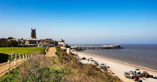 Scenic view of beach against clear blue sky