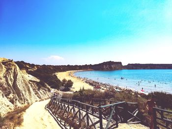 Scenic view of beach against clear blue sky