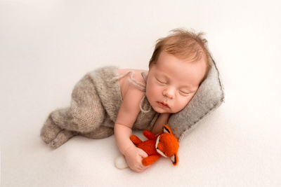 Portrait of cute girl with teddy bear against white background