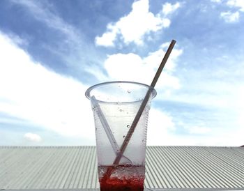 Close-up of drink against cloudy sky
