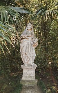 Statue of tree against plants