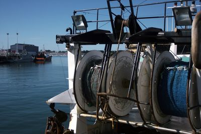 Close-up of ship moored at harbor against clear sky