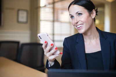 Entrepreneur businesswoman working at table in office on mobile