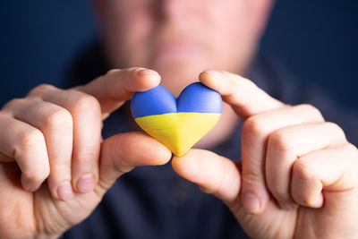 Close-up of hand holding heart shape