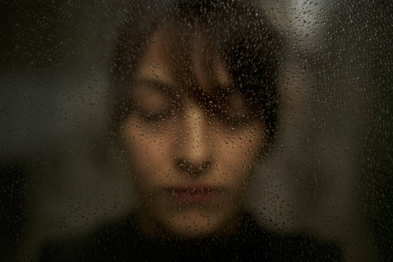 window, drop, wet, only women, adults only, loneliness, one woman only, adult, one person, indoors, human face, close-up, human body part, portrait, fine art portrait, people, beautiful woman, water, women, looking at camera, human eye, one young woman only, young adult, day