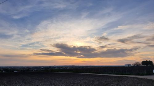 Scenic view of field against sky during sunset