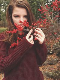 Portrait of young woman with berries