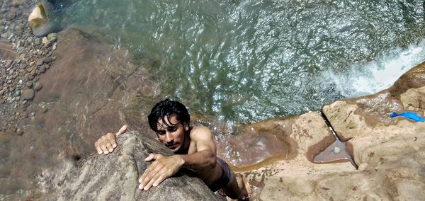 High angle view of young man swimming in sea