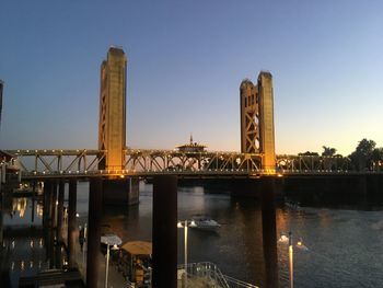 Bridge over river against buildings