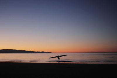 Scenic view of sea against clear sky during sunset