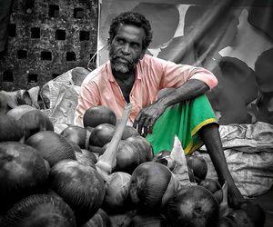 Portrait of man holding food at market