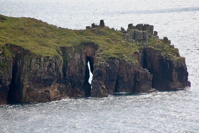 Scenic view of rock formation by sea