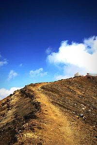 Low angle view of mountain against blue sky