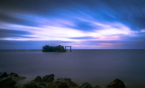 Scenic view of sea against sky at sunset