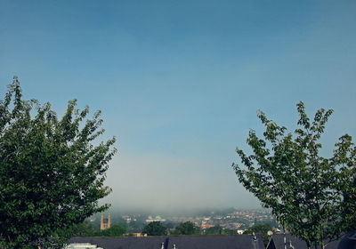 View of cityscape against blue sky