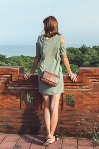 Rear view of woman standing against sky