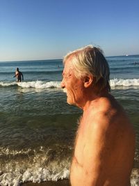 Man looking at sea against clear sky