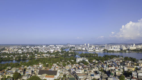 High angle view of townscape by sea against sky