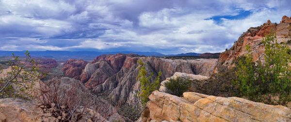 Panoramic view of rocky mountains against cloudy sky