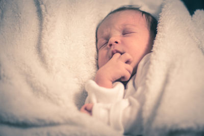 Cute baby sleeping with finger in mouth