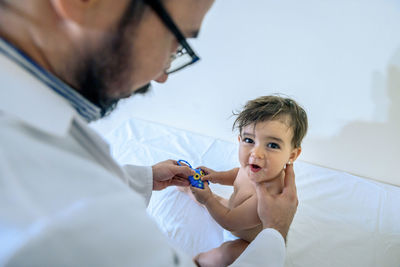 Doctor observing a one-year-old baby