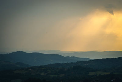 Scenic view of silhouette mountains against sky during sunset