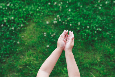 Cropped image of child over field