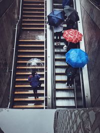 Rear view of people working at staircase