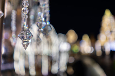 Close-up of lighting equipment hanging from glass