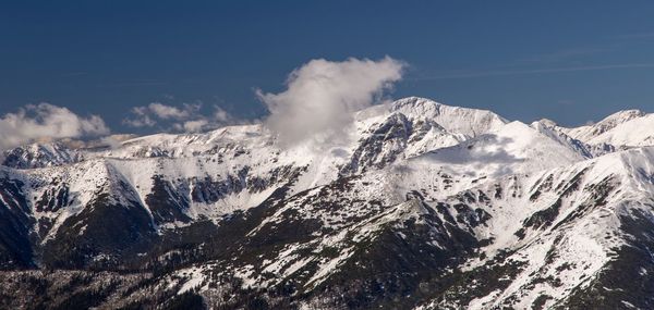 Scenic view of snowcapped mountains against sky