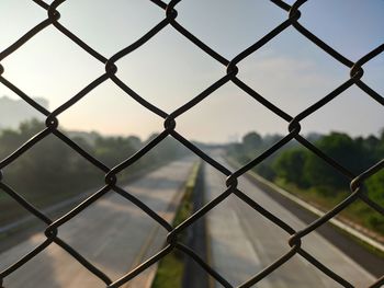 Full frame shot of chainlink fence against sky