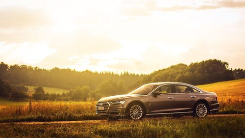 Car on field against sky