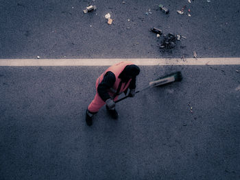 High angle view of woman lying on road