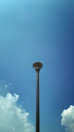Low angle view of street light against blue sky