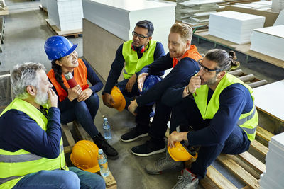 Workers in factory having lunch break together