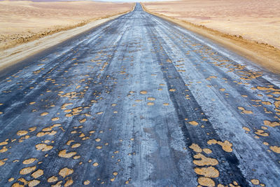 Empty damaged country road on landscape